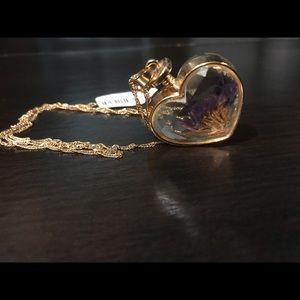 Gold heart shaped necklace with flowers inside